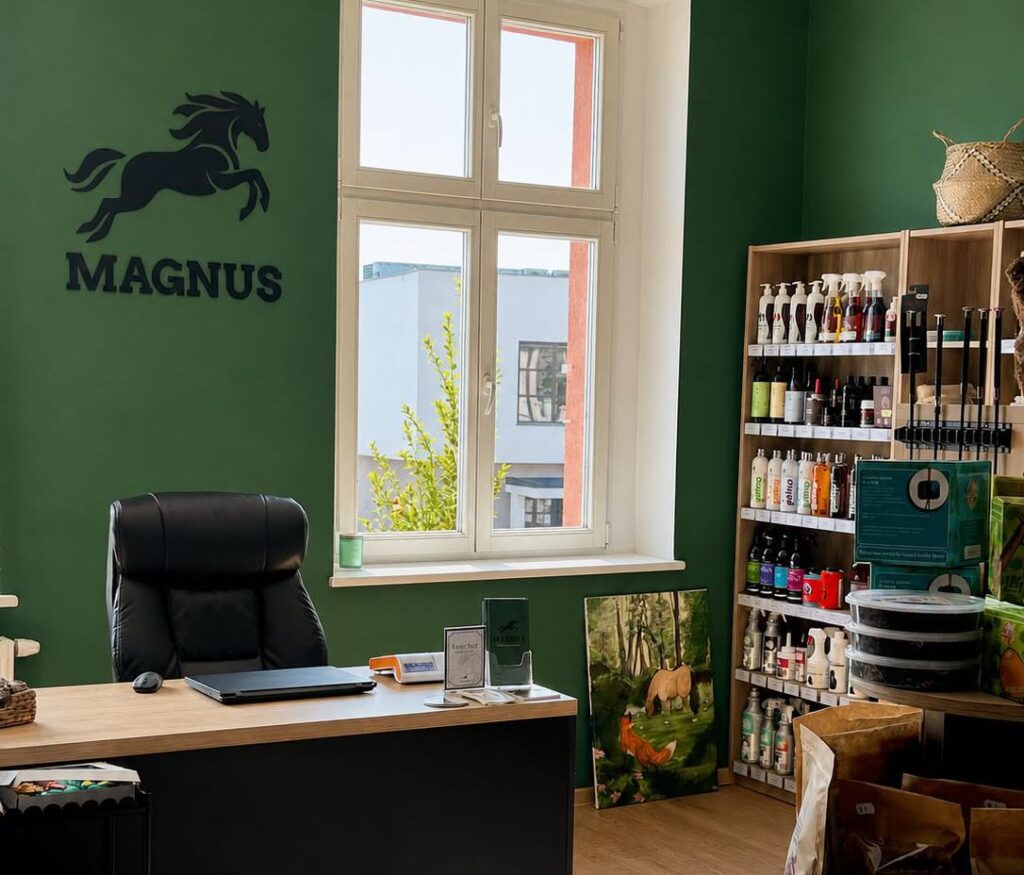Wnętrze sklepu jeździeckiego Magnus w Kórniku z logo sklepu i stanowiskiem obsługi